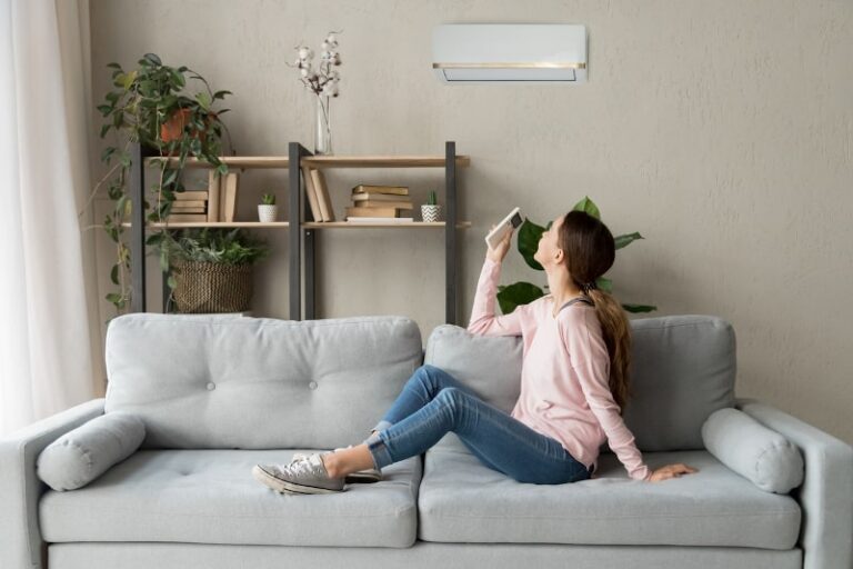 woman with remote for ductless mini-split